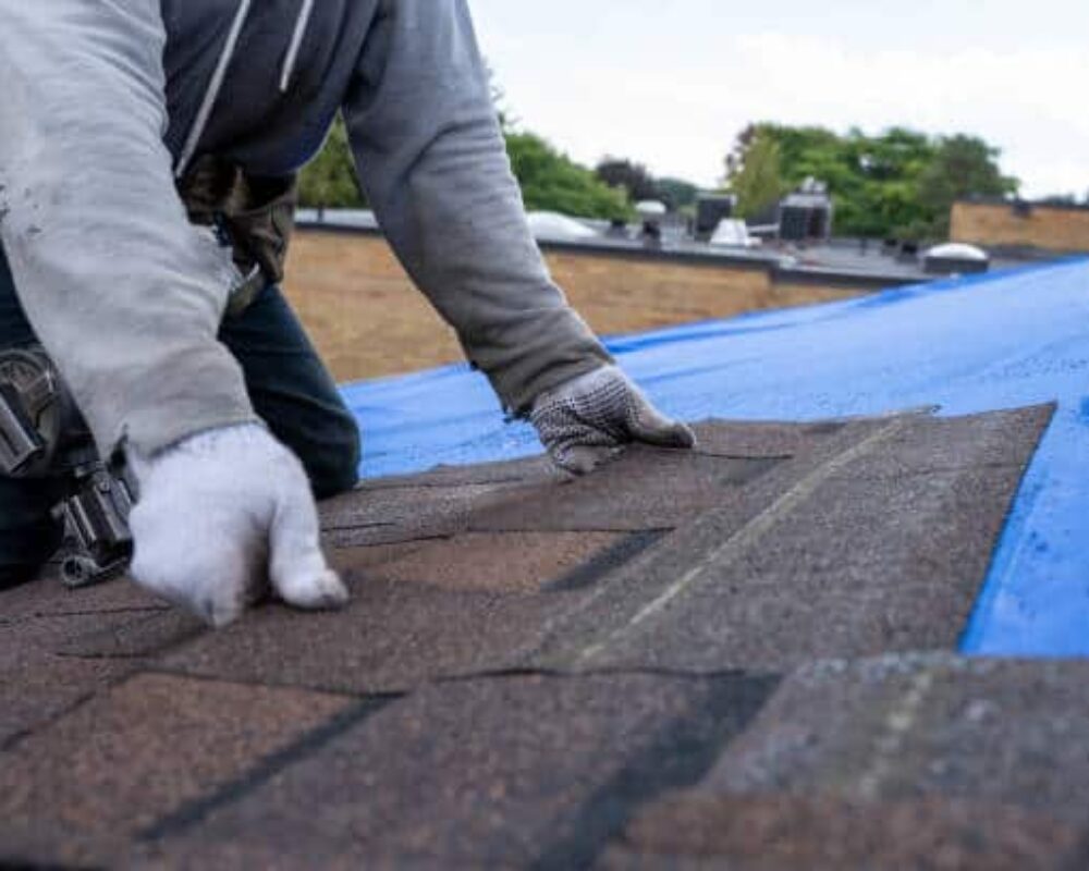 Roofers installing new roof on house